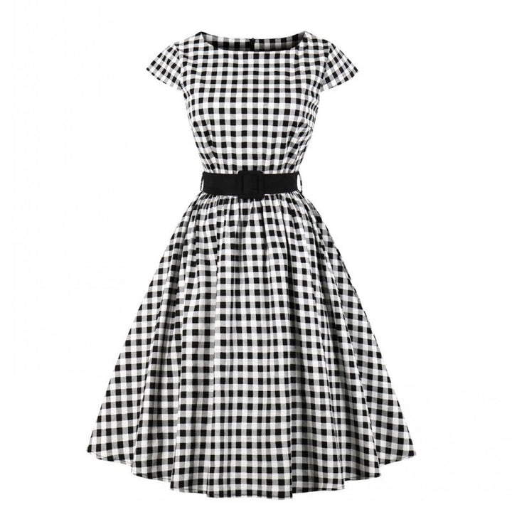 Georgina was wearing this Black and White Gingham Dress today! At lunch, we had been hotly discussing the fashion of the 50's. There were so many things to admire about the era but most important to us? The perfect red lip and timeless femininity!